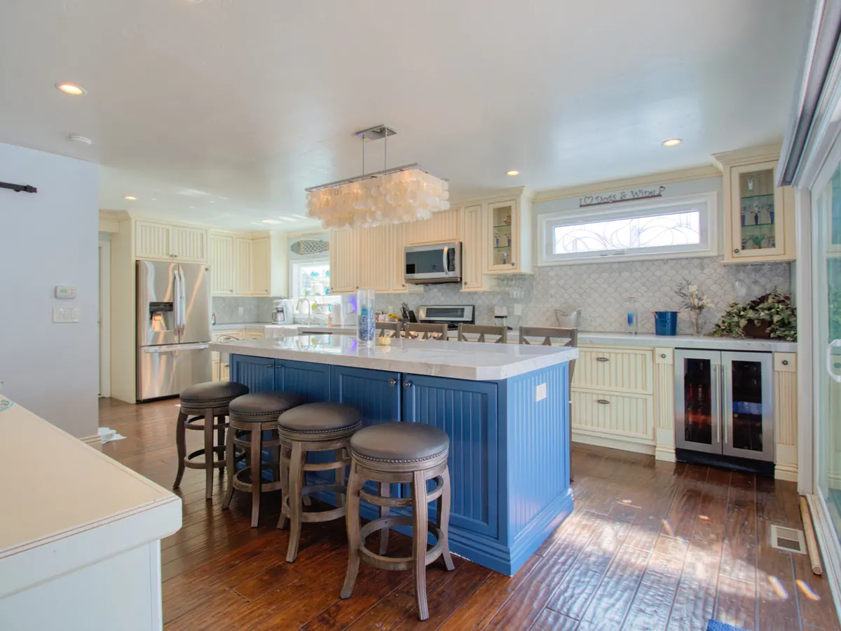 Coastal kitchen with blue island and white cabinetry