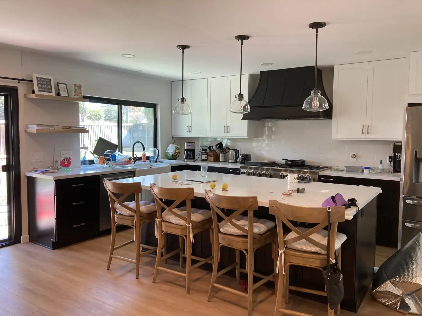 White kitchen with island seating remodeled by Laguna Bay Developing