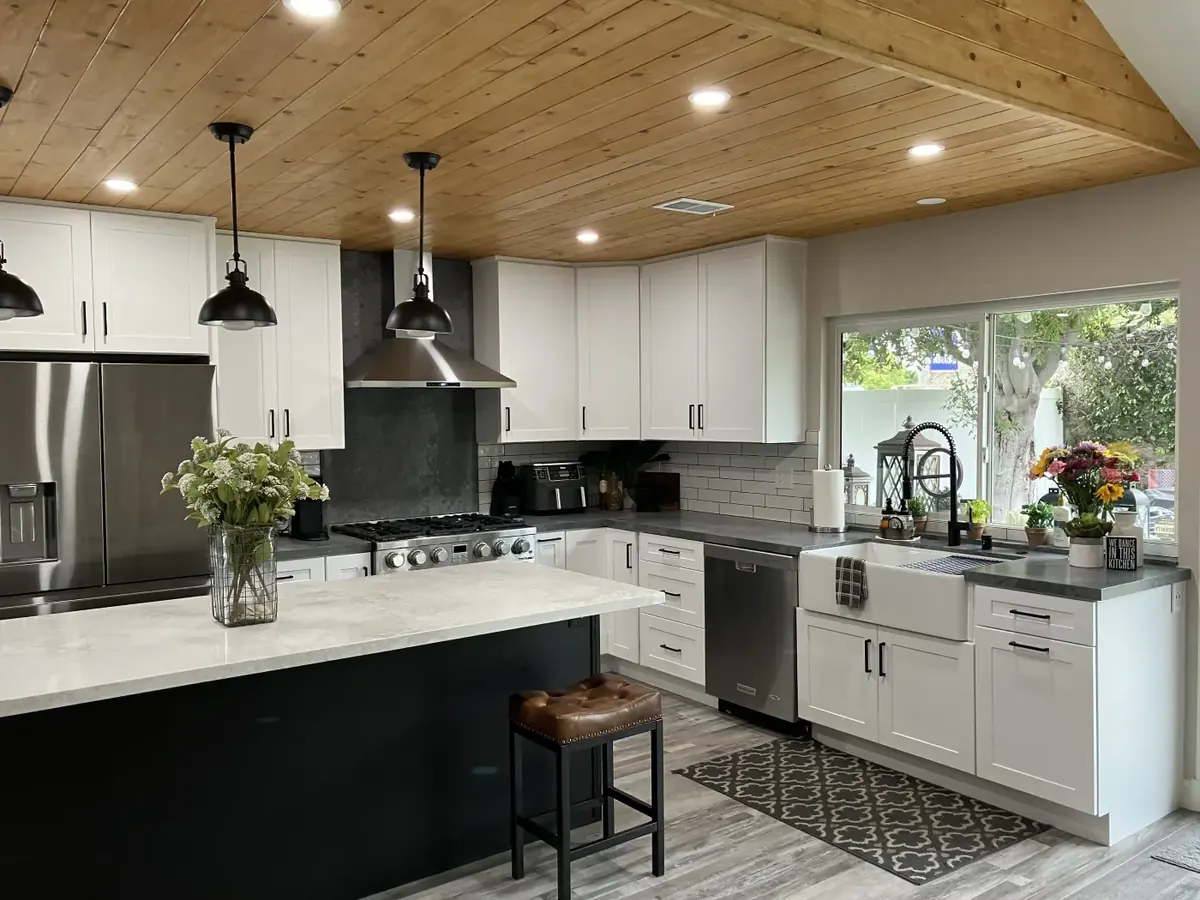 Kitchen with wood ceiling and dark island